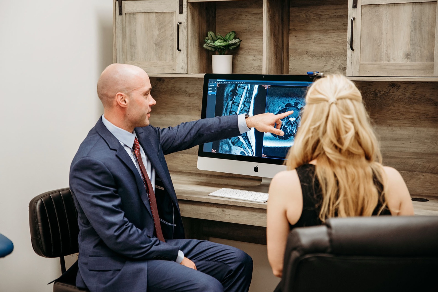 Dr. Loch reviewing MRI images with a patient