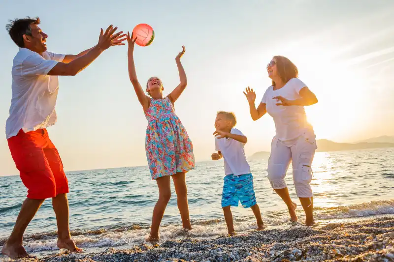 family playing on the beach